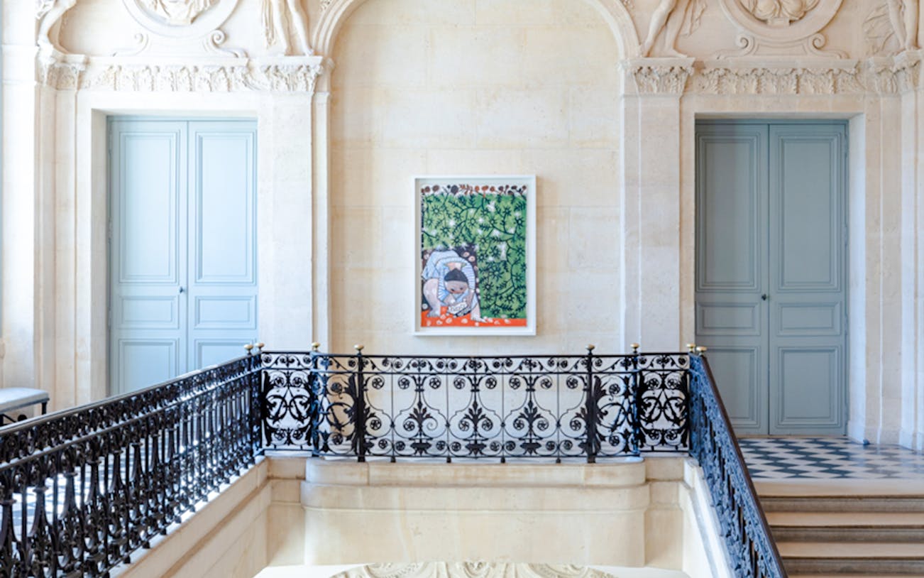Artwork displayed in the Picasso Museum, Paris, featuring a colorful painting on a decorative wall.