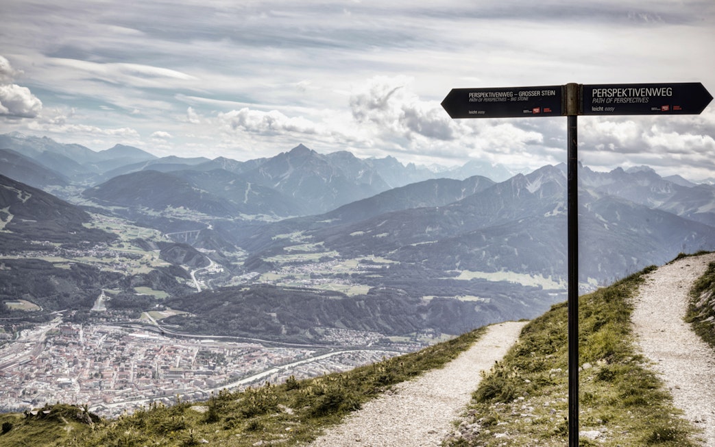 Nordkettenbahn mountain view with signpost on hiking trail, Innsbruck, Austria.