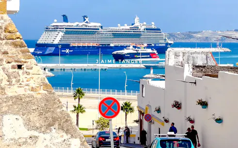 Cruise ship docked at Tangier port with view of Medina street and Kasbah wall.