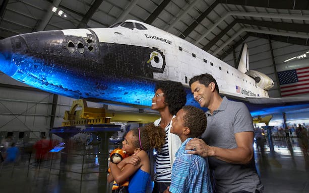 Family admiring Space Shuttle Endeavour at California Science Center, Los Angeles.