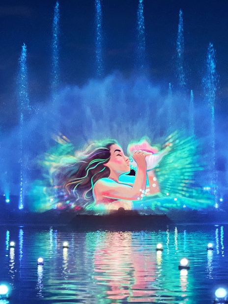Disneyland World of Frozen Illuminations with vibrant water and light show.