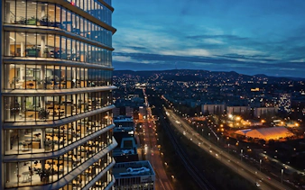 SkyDeck view from MOL Campus overlooking Budapest cityscape at dusk.