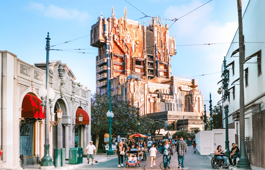 Guardians of the Galaxy HQ building at Disneyland, California with visitors walking nearby.