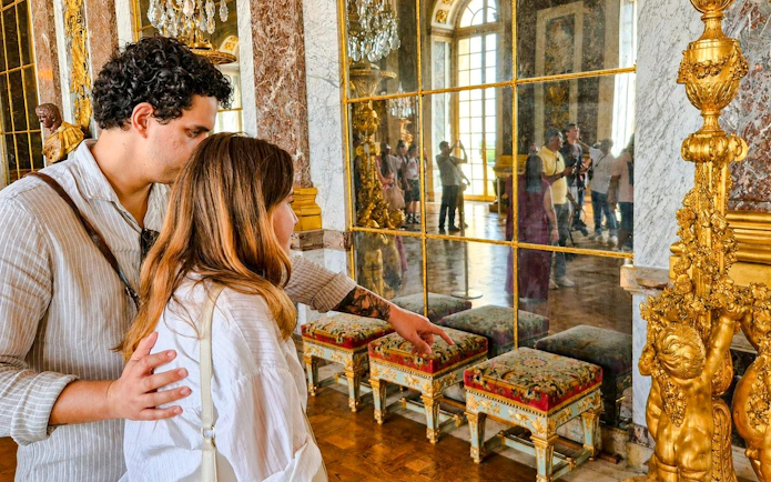 Visitors exploring the Hall of Mirrors at Versailles Palace during a private guided tour.