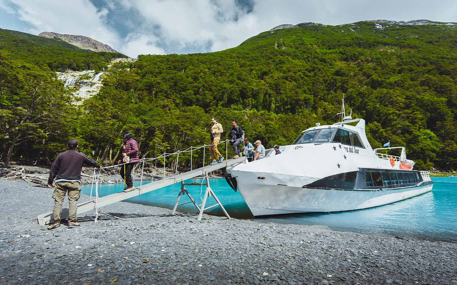 Passengers deboarding boat for Mayo Spirit Trek on Lake Argentino, Patagonia, Argentina.