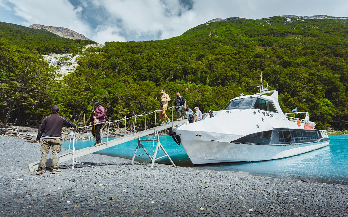 Passengers deboarding boat for Mayo Spirit Trek on Lake Argentino, Patagonia, Argentina.