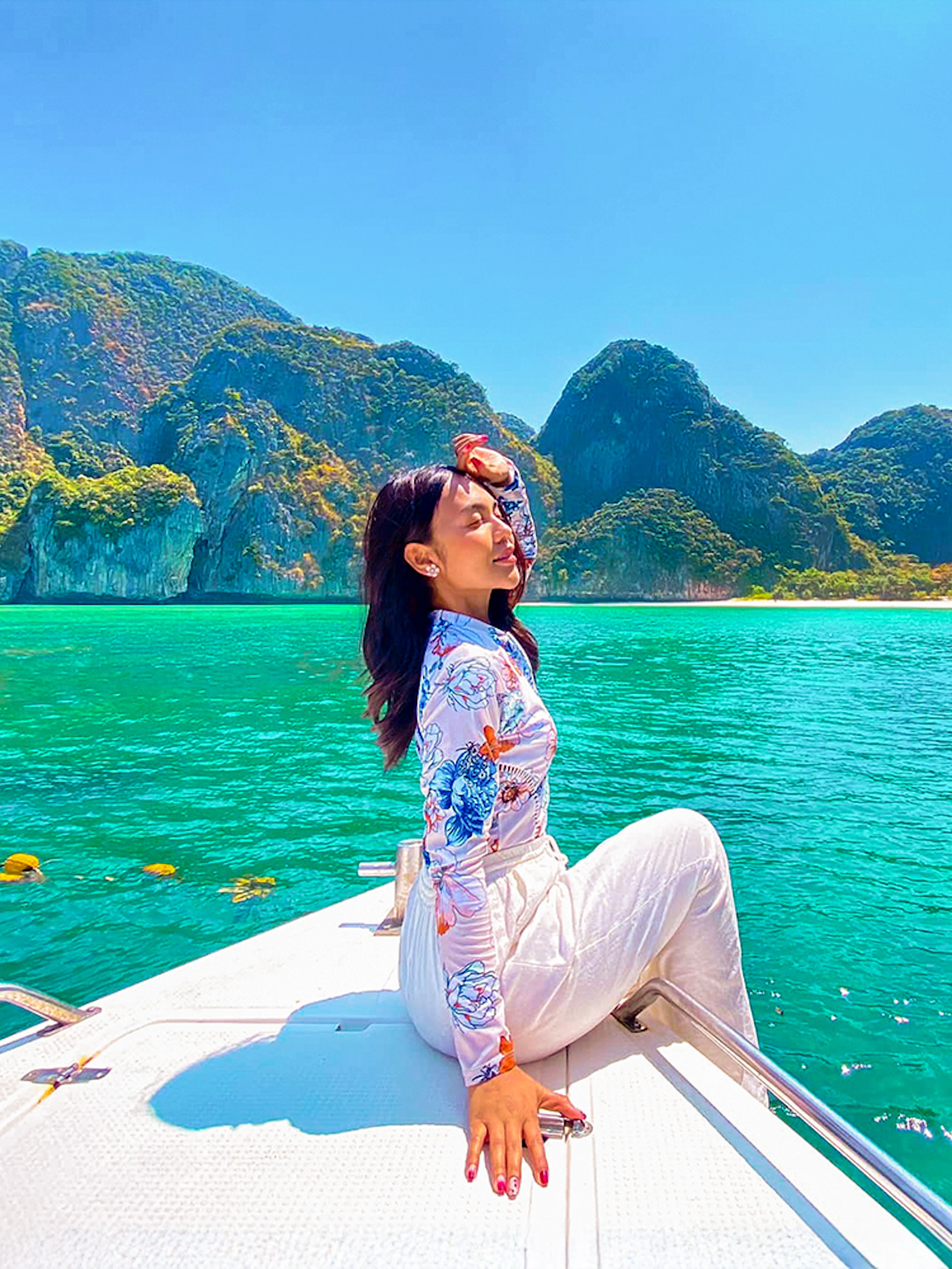 Woman enjoying a boat ride in Krabi with view of Phi Phi Islands.