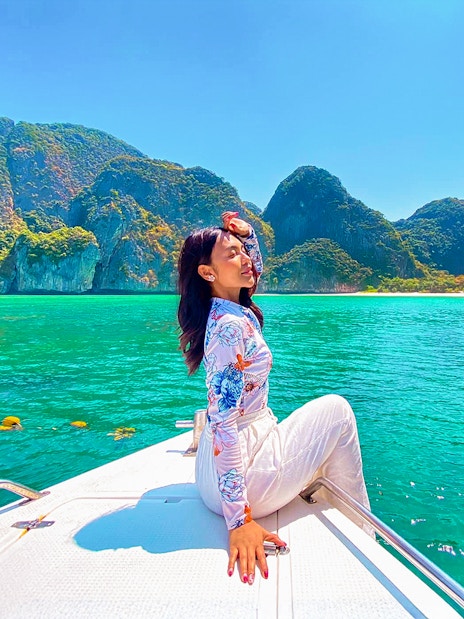 Woman enjoying a boat ride in Krabi with view of Phi Phi Islands.