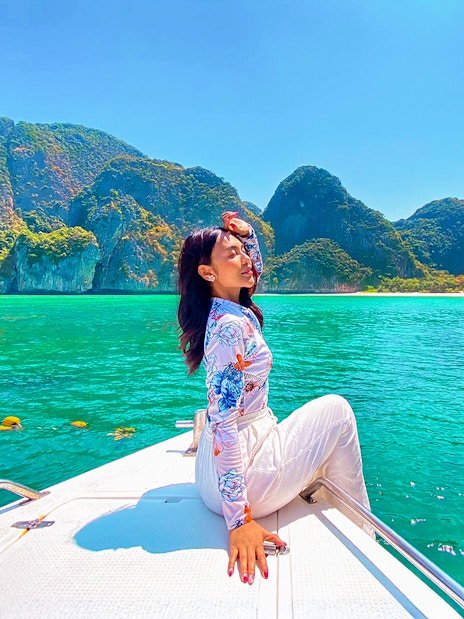 Woman enjoying a boat ride in Krabi with view of Phi Phi Islands.