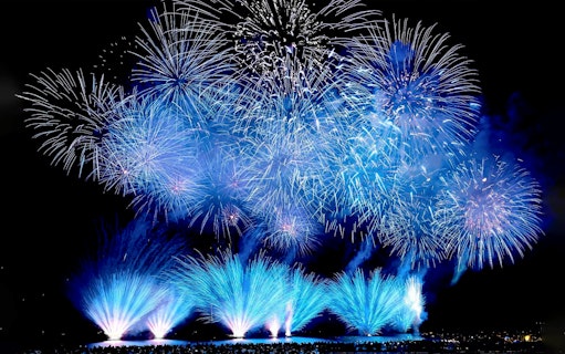 Fireworks display at night during Huis Ten Bosch event in Japan.