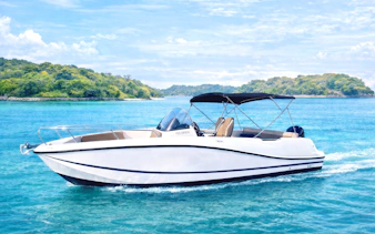 Speedboat "The Sun, Sea & Me" moored in Sentosa marina, Singapore near waterfront apartments.
