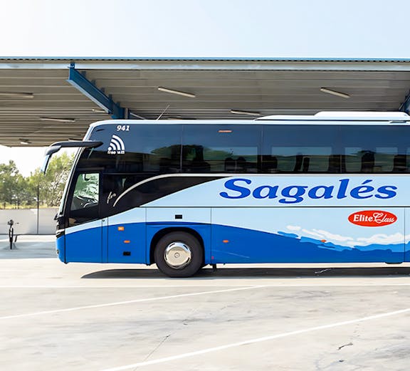 Blue and white Sagales bus at Girona Airport transfer station.