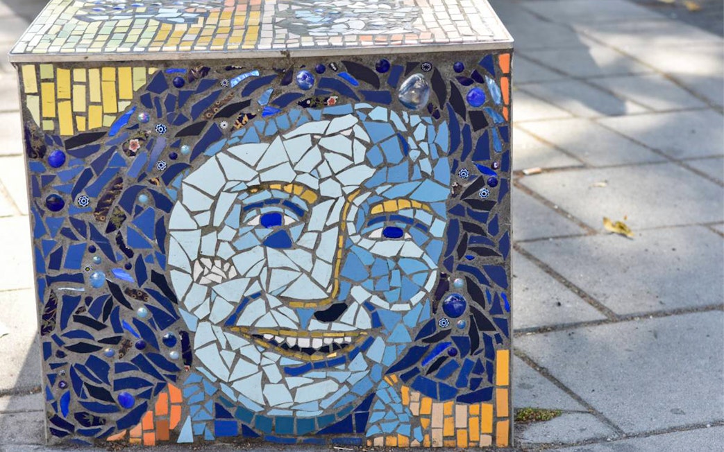 Anne Frank mosaic artwork on a sidewalk in Amsterdam.