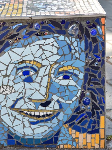 Anne Frank mosaic artwork on a sidewalk in Amsterdam.