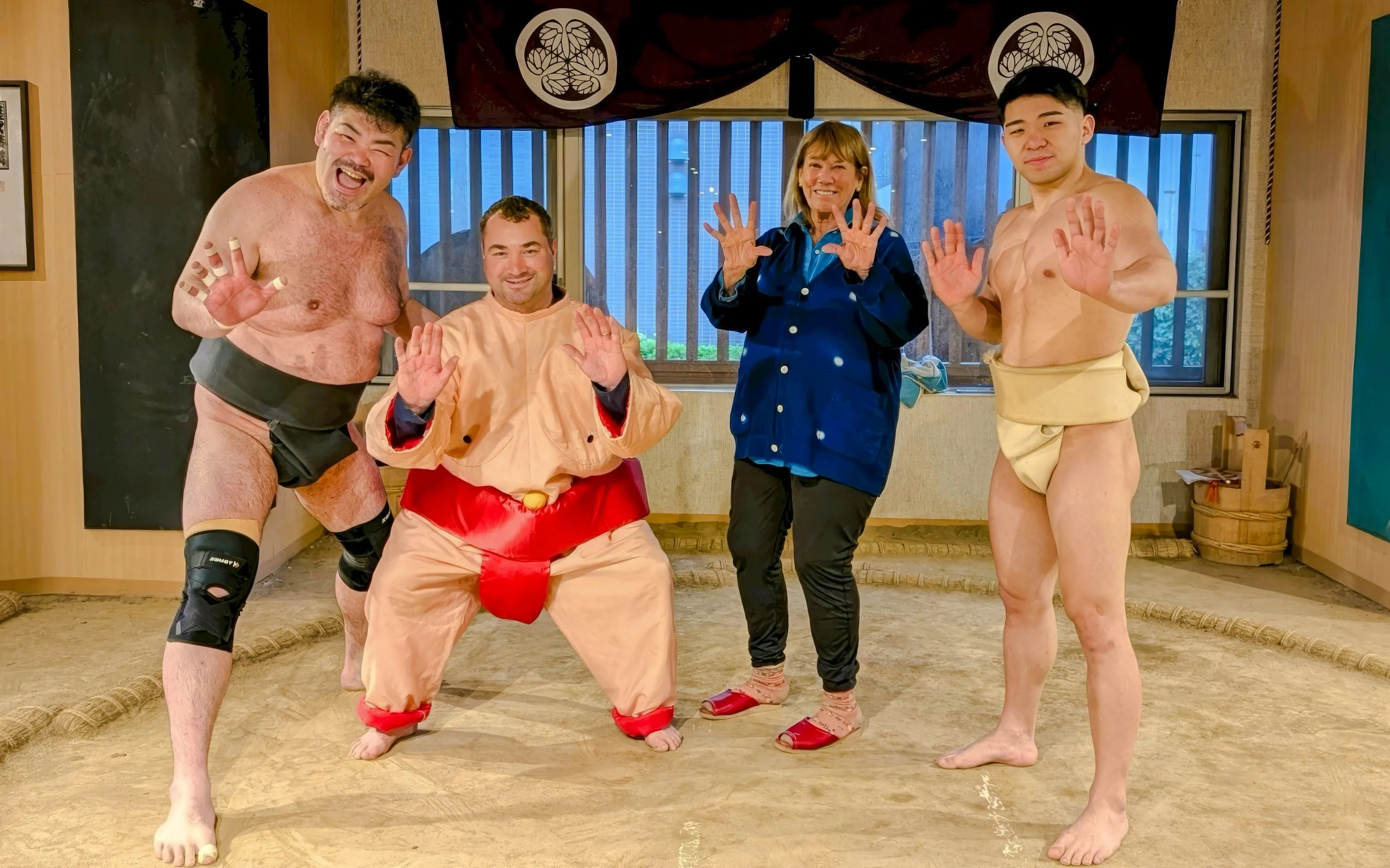 Tourist with sumo wrestlers at Tokyo Family Sumo Workshop.