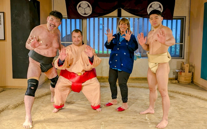 Tourist with sumo wrestlers at Tokyo Family Sumo Workshop.
