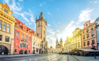Old Town Hall with clock tower on Old Town Square, Prague, under a clear sky.
