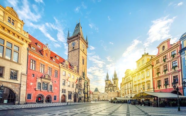 Old Town Hall with clock tower on Old Town Square, Prague, under a clear sky.