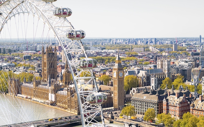 London Eye Ferris wheel overlooking Big Ben and the Houses of Parliament.