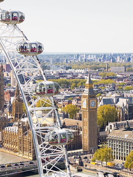 London Eye Ferris wheel overlooking Big Ben and the Houses of Parliament.