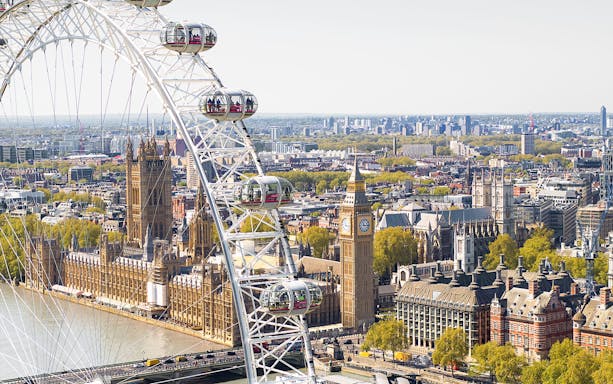 London Eye Ferris wheel overlooking Big Ben and the Houses of Parliament.