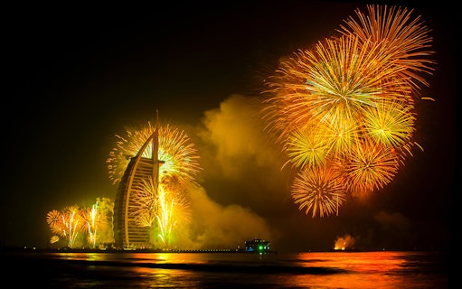 Fireworks display over Burj Al Arab during Dubai New Year 2024 celebration.