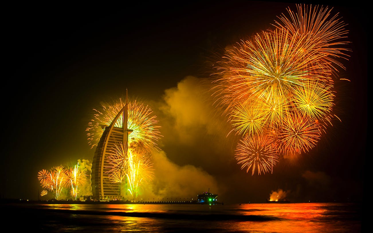 Fireworks display over Burj Al Arab during Dubai New Year 2024 celebration.