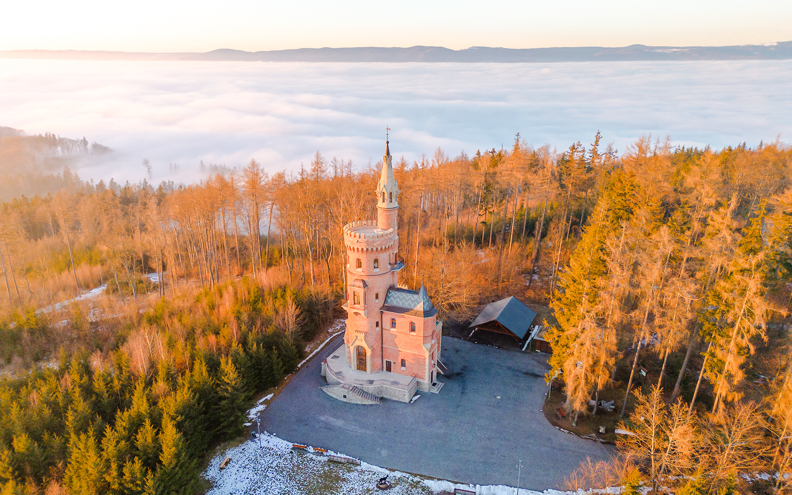 Goethe’s Lookout Tower surrounded by forest and mist in Prague.