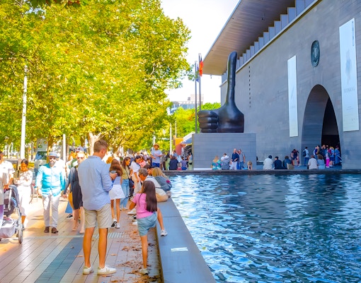 People walking near the entrance of the National Gallery of Victoria, Melbourne.