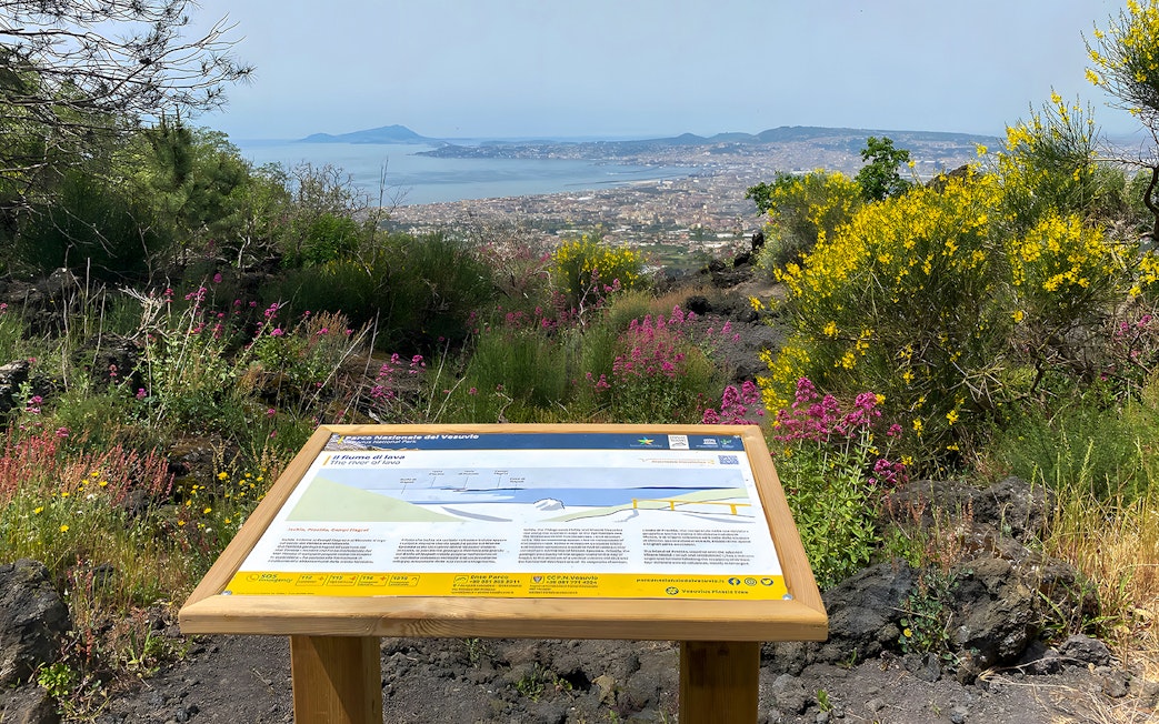 Information board about Mount Vesuvius with view of Naples and surrounding landscape.