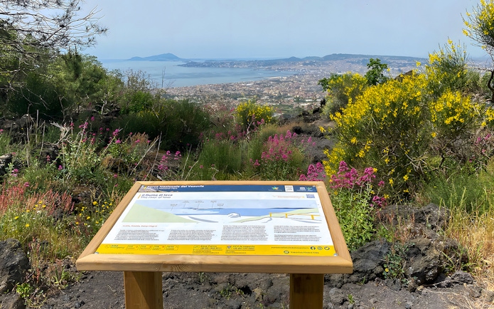 Information board about Mount Vesuvius with view of Naples and surrounding landscape.