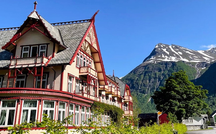 Hotel Union Øye with mountain backdrop in Hjørundfjord, Norway.