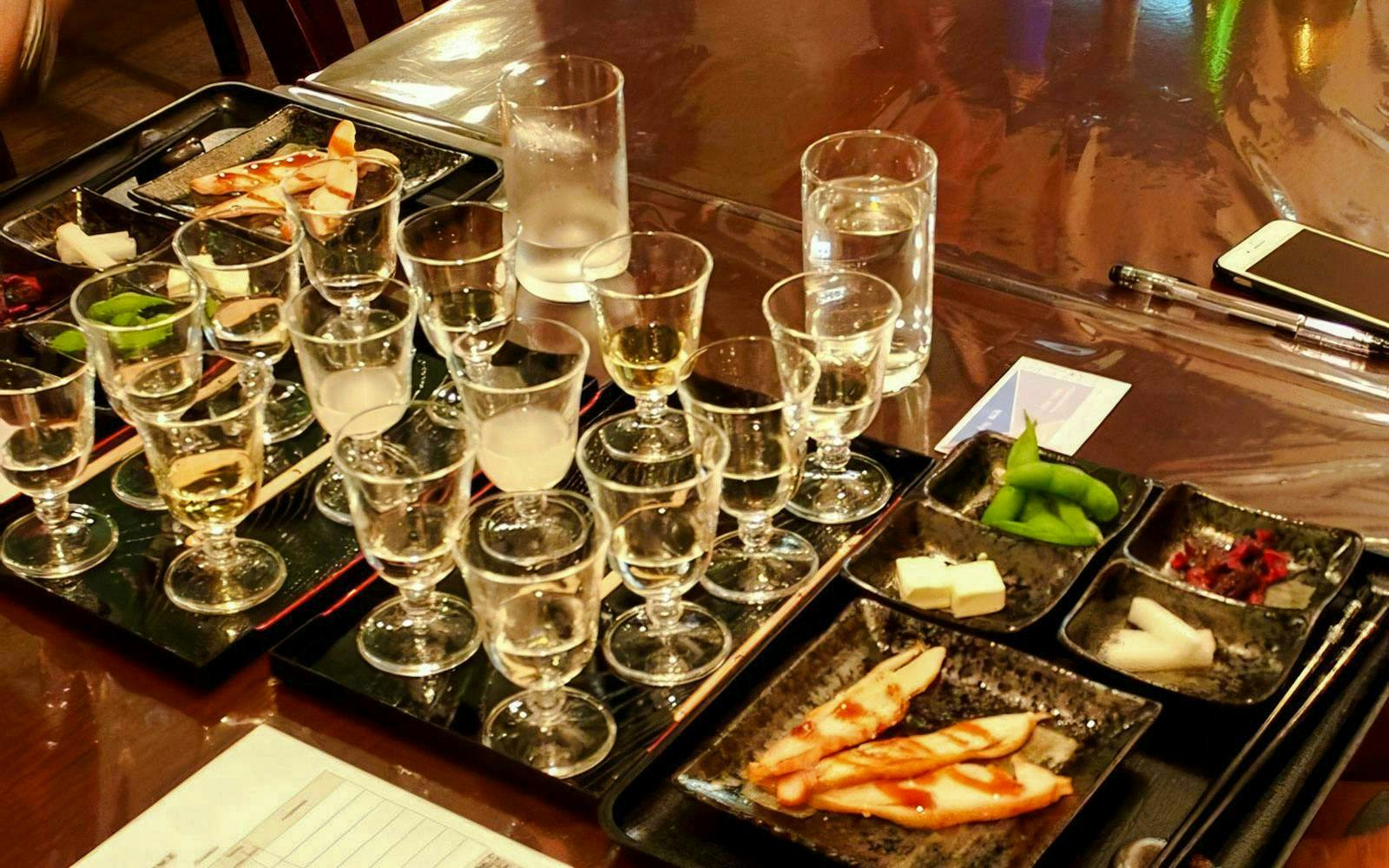 Sake glasses and tasting dishes at Kyoto Insider Sake Experience.
