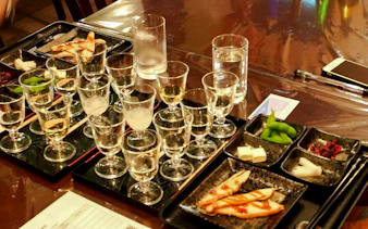Sake glasses and tasting dishes at Kyoto Insider Sake Experience.