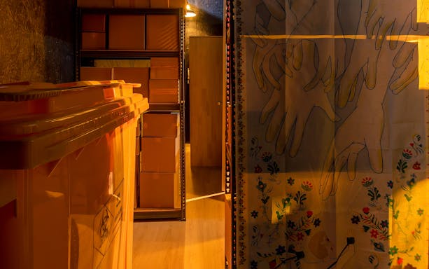Storage room with orange bins and shelves of boxes at Malaysia Breakout The Curve Spy Game.