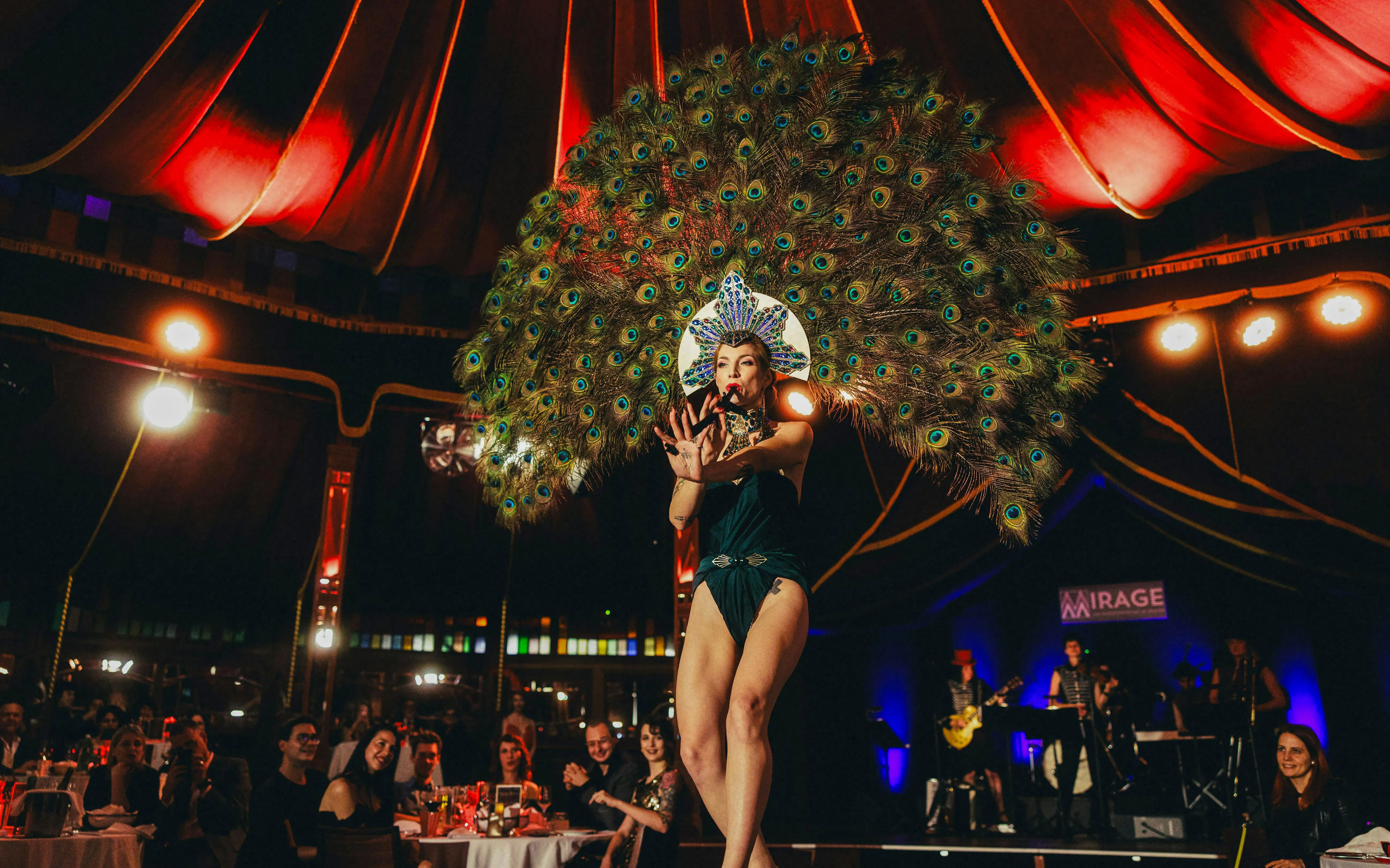 Performer in peacock costume at The Mirage dinner show, Burlesque, Vienna.