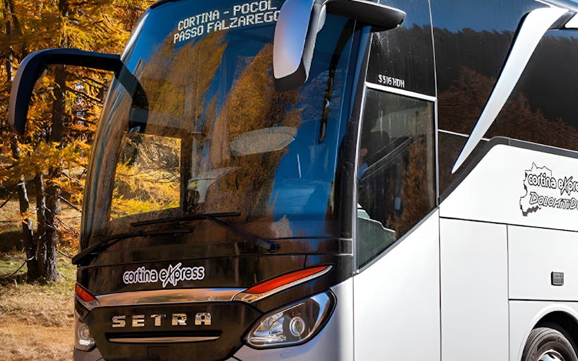 Shuttle bus on route from Marco Polo Airport through scenic autumn landscape.