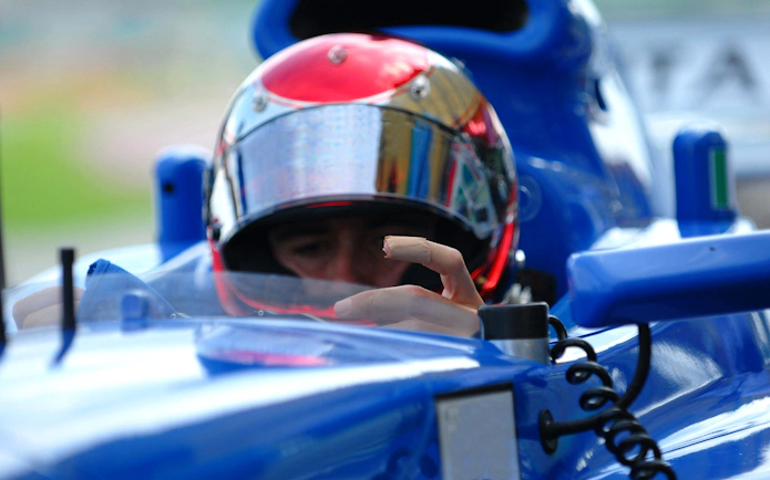 Race car driver in cockpit at A1 Grand Prix, Sepang, Malaysia.