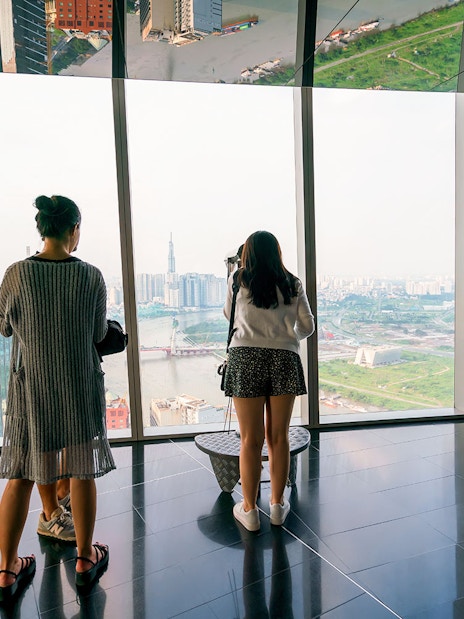 Visitors enjoying the panoramic view from a sky deck in downtown Ho Chi Minh City, Vietnam.