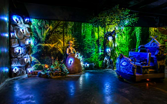 Guests enjoying illuminated jungle-themed ride at Vialand Theme Park, Istanbul.