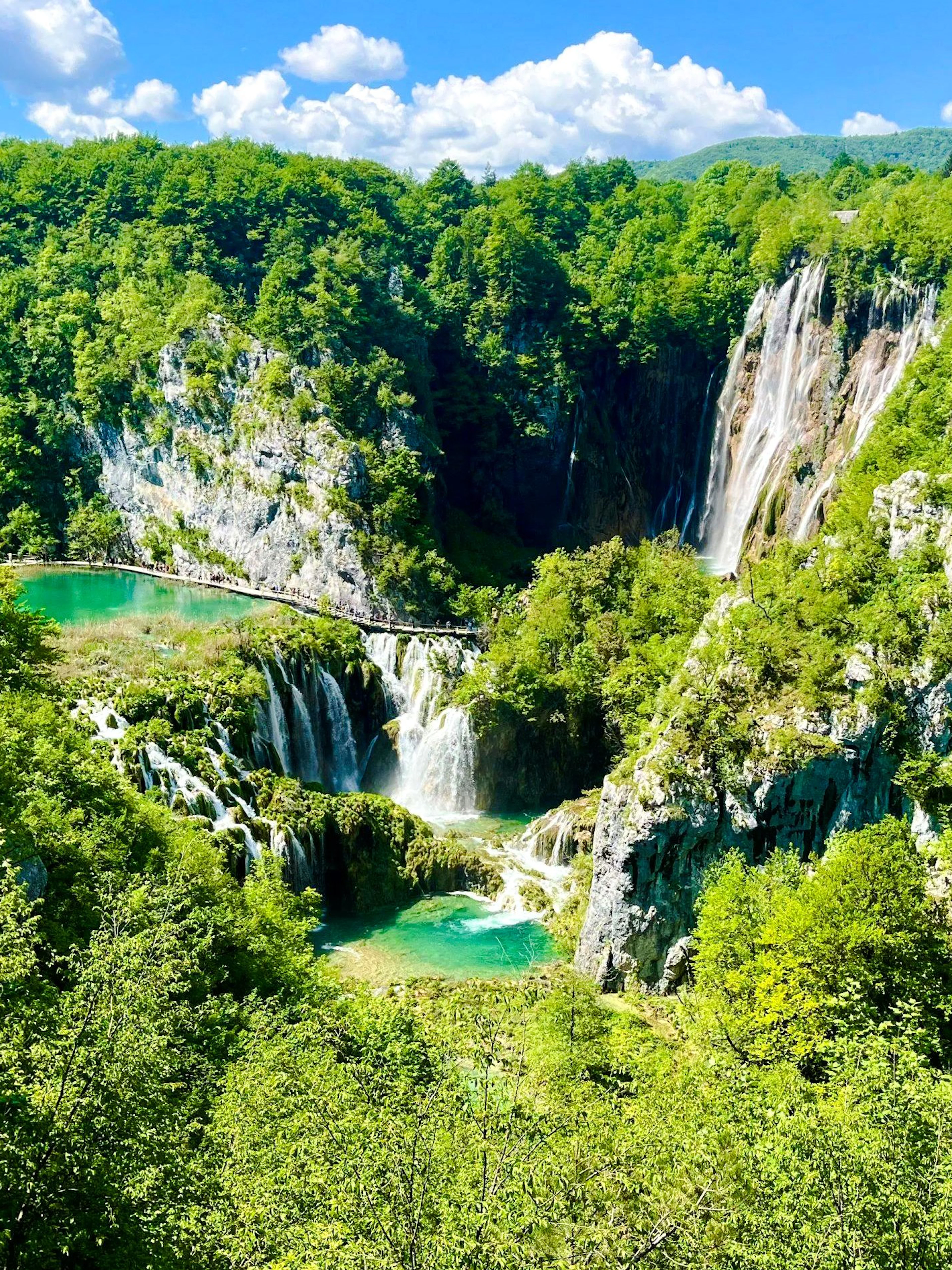 Aerial view of waterfalls and lush greenery at Plitvice National Park, Croatia.