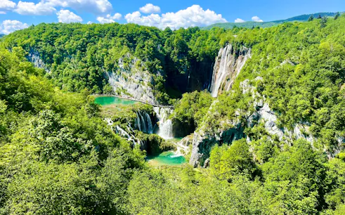 Aerial view of waterfalls and lush greenery at Plitvice National Park, Croatia.