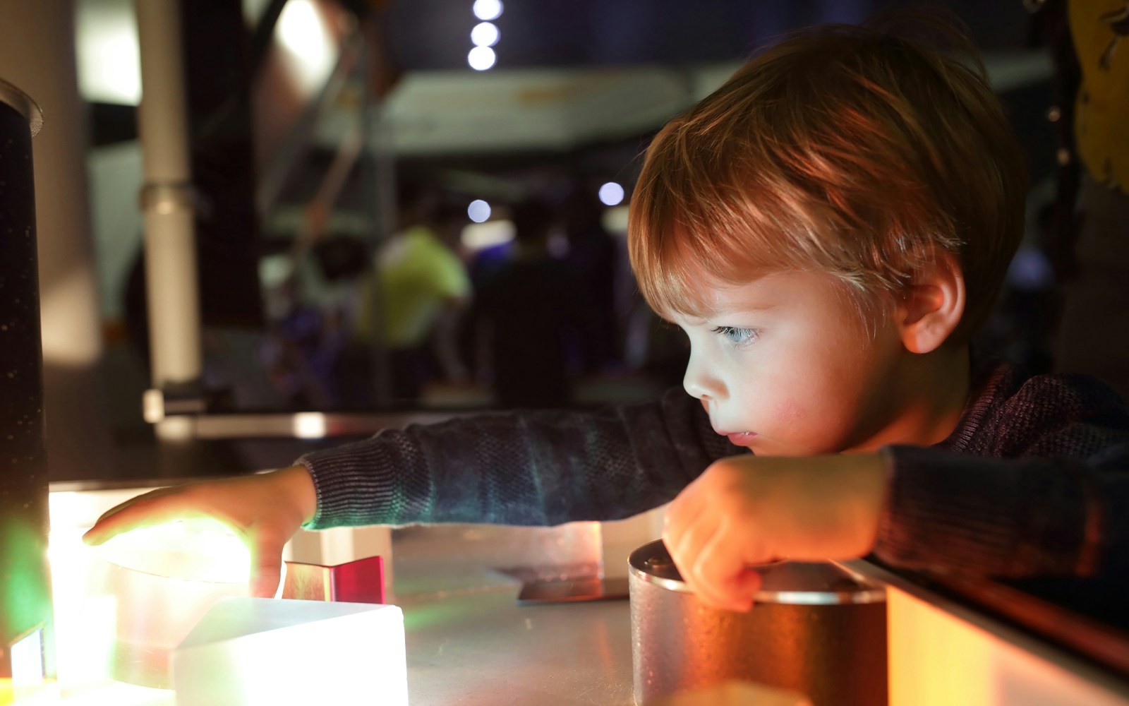 Child exploring interactive exhibit at NEMO Science Museum, Amsterdam.