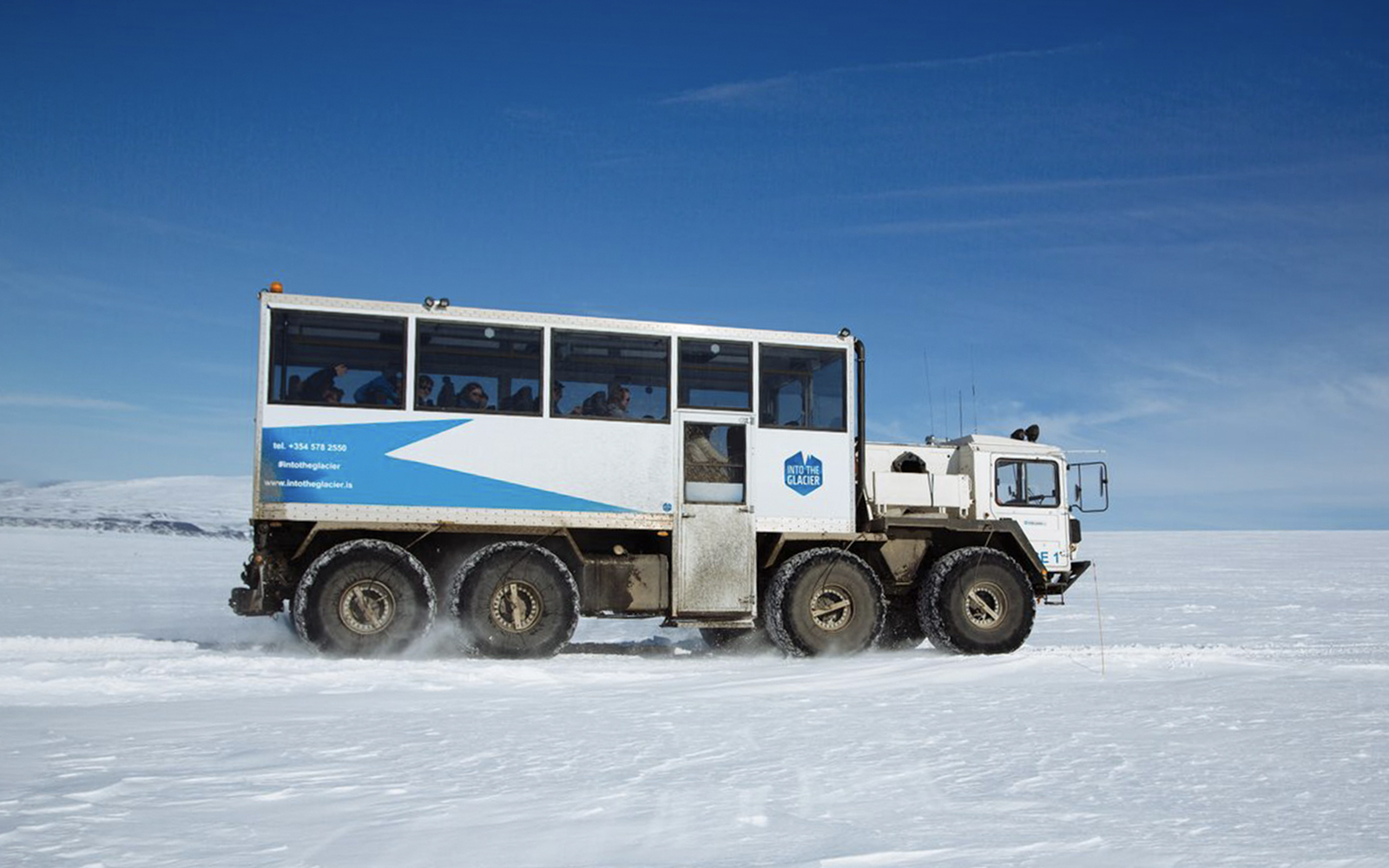 Guests traveling in a glacier vehicle from Husafell to Langjökull in Iceland.