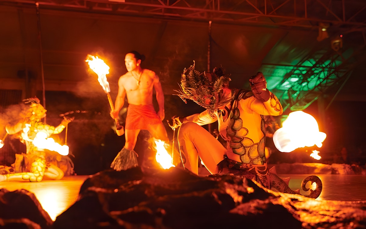 Fire dancers performing at Luau Kalamaku cultural show in Hawaii.