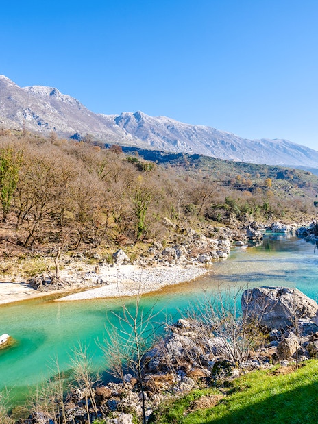 Vjosa River flowing through a mountainous landscape in Albania.