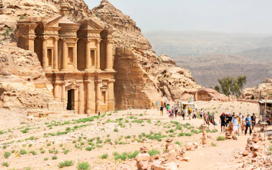 A-Dir Monastery in Petra, Jordan with tourists exploring the ancient site.