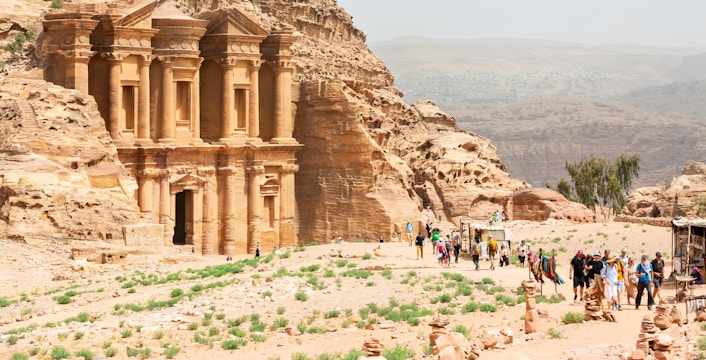 A-Dir Monastery in Petra, Jordan with tourists exploring the ancient site.