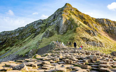 Visitors walking on basalt columns at Giant's Causeway, Northern Ireland.