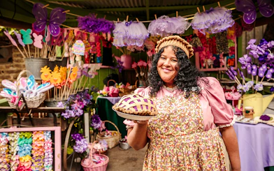Vendor holding boysenberry pie at Knott's Boysenberry Festival, Knott's Berry Farm.